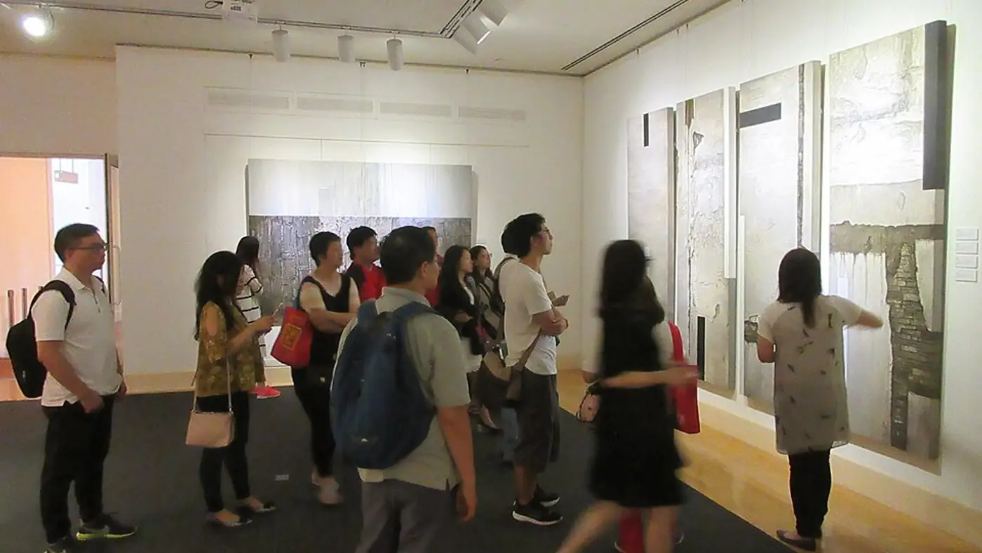 Visitors queue along Campbell Parade for a Bondi gallery summer exhibition