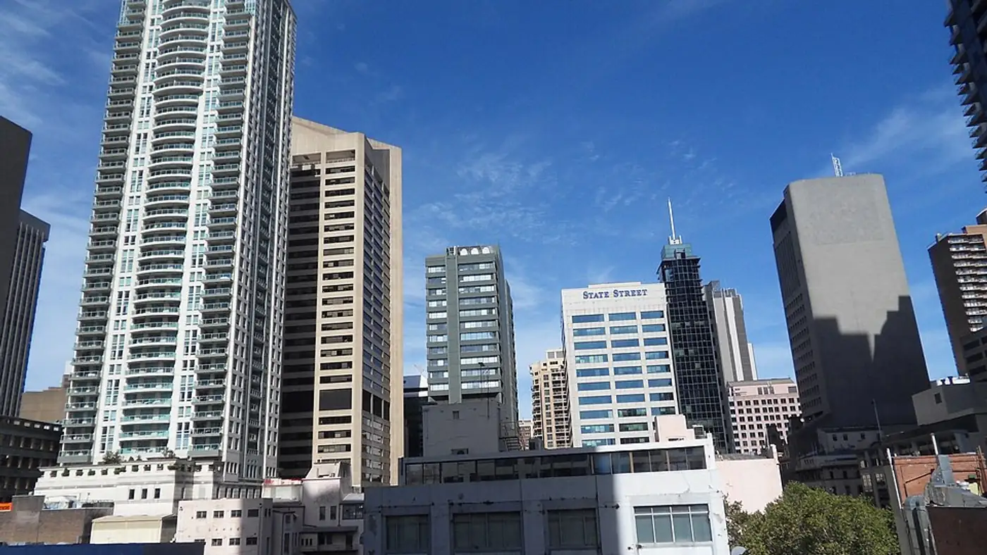 Half-demolished central business district office tower with residential floor plans overlaid
