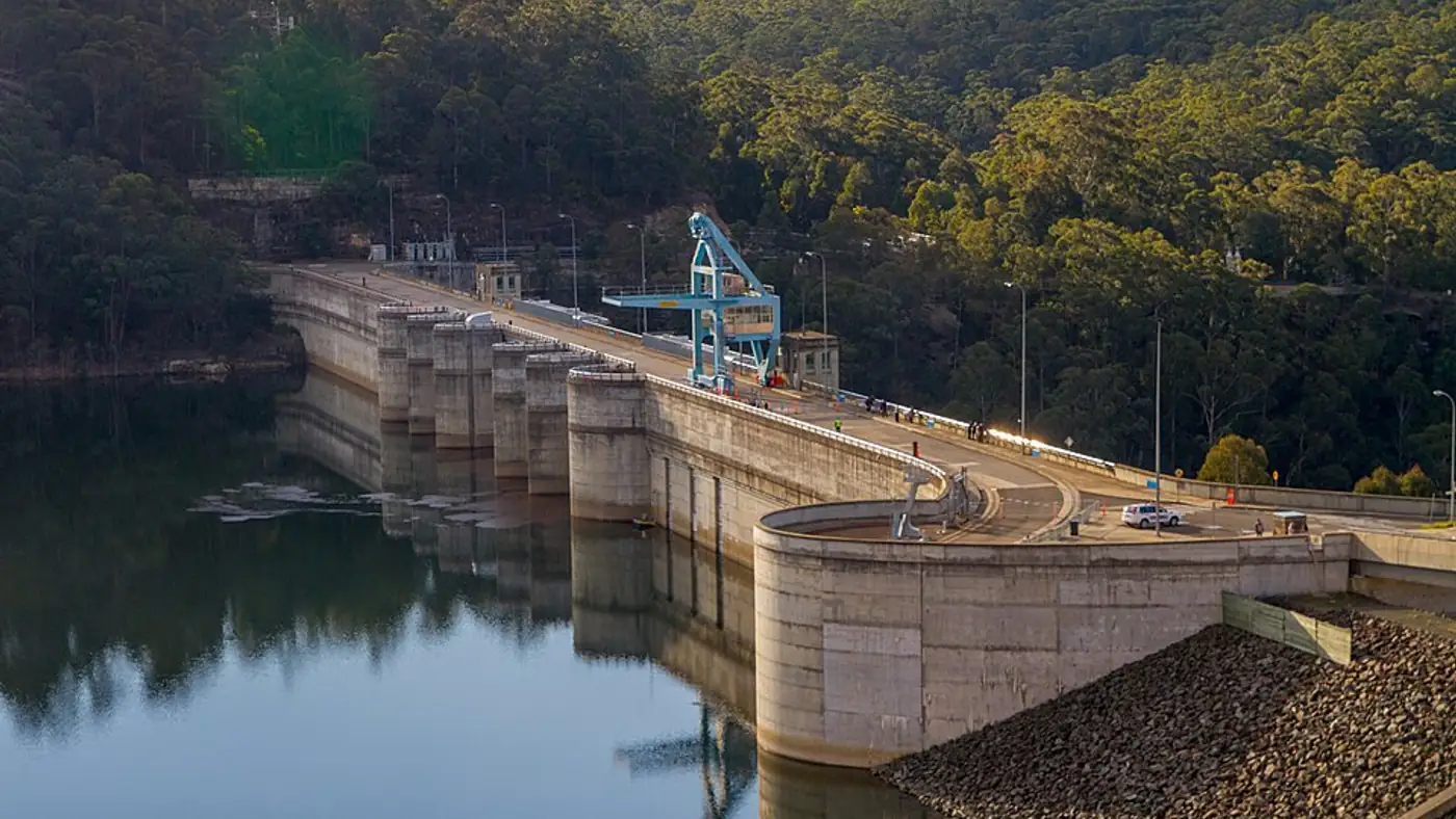 Large open water reservoir surrounded by dry earth under a wide sky