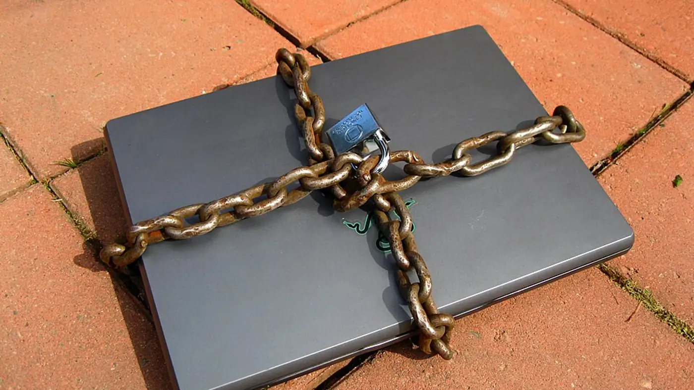 Laptop displaying a security dashboard on a small business desk with coffee cup